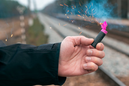 The Firecracker in a Hand. Man Holding a Burning Petard in His Hand. A Human with a Pyrotechnics...