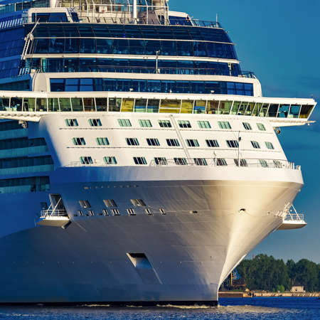 White giant brand new passenger ship moving in clear summer dayの写真素材