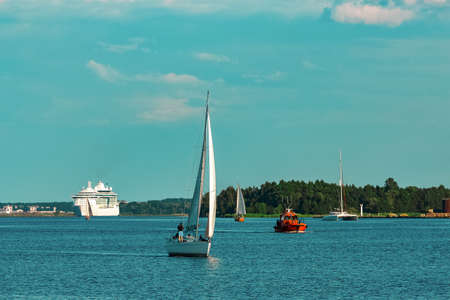 Beautiful white sailboat in a travel by Riga. Summer journeyの写真素材