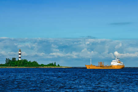 Yellow cargo tanker ship moving at the clear summer dayの写真素材