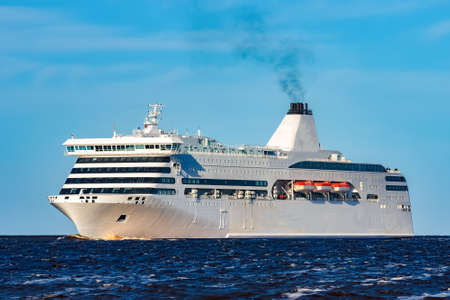 White cruise liner sailing on a clear dayの写真素材