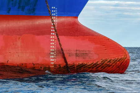 Blue cargo ship moored in still Baltic sea water