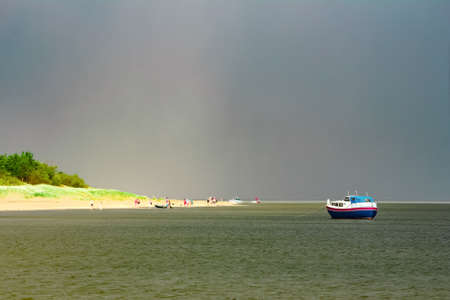 Small blue passenger ship moored at Baltic sea bay