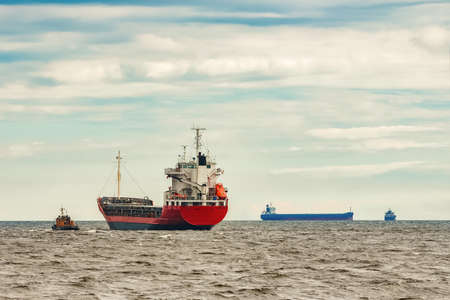 Red new cargo ship moving abroad. Product export in Europeの写真素材