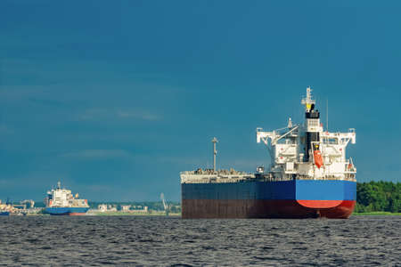 Merchandise import. Large blue cargo ship moving to Riga portの写真素材