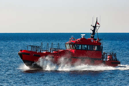 Red pilot ship moving from the Baltic seaの写真素材