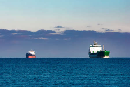 Cargo ships far in still water of Baltic seaの写真素材