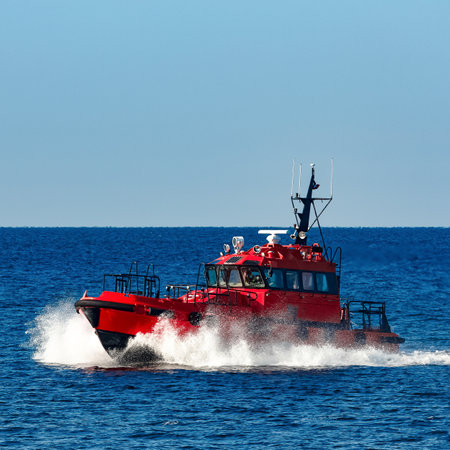 Red pilot ship moving from the Baltic seaの写真素材