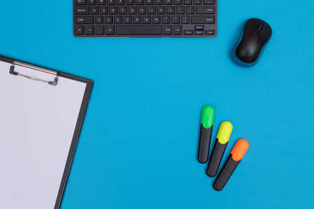 Office Workplace with Digital Gadgets Lying on Blue Table - Flat Layの写真素材