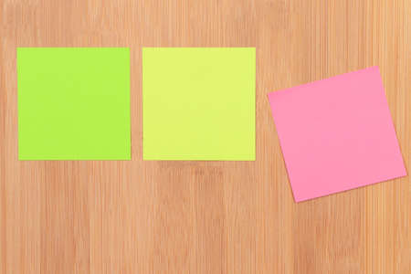 Colored Sticky Notes with Copyspace Pinned to the Wooden Message Board. To Do List Reminder in...