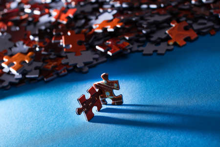 Mixed Peaces of a Colorful Jigsaw Puzzle Lie on the Blue Background - Strategy and Solving Problem Conceptの写真素材