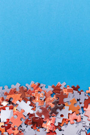Mixed Peaces of a Colorful Jigsaw Puzzle Lie on the Blue Background With Copy Space - Strategy and Solving Problem Conceptの写真素材