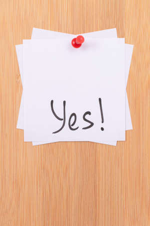 YES! - White Sticky Notes with Written Word YES, Pinned to the Wooden Message Board. To Do List Reminder in the Office. Memo Note at Workの写真素材