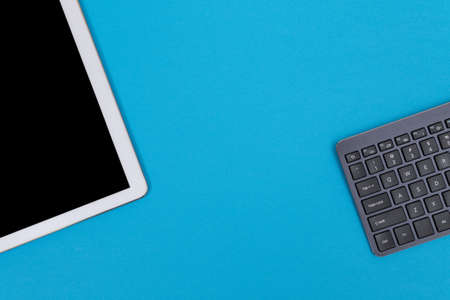 Office Workplace with Digital Gadgets Lying on Blue Table - Flat Lay