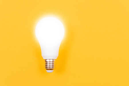 Power Saving Lamp on Yellow Background - Top Viewの写真素材