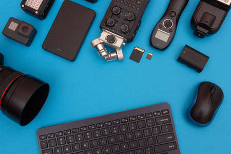 Top View of Photographers, Videographers or Video Bloggers Workplace. Digital Gadgets Lying on Blue Table - Flat Layの写真素材