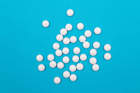 Global Pharmaceutical Industry and Medicinal Products - White Pills on Blue Backgroundの写真素材