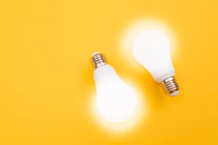 A Power Saving Lamps on Yellow Background - Top Viewの写真素材