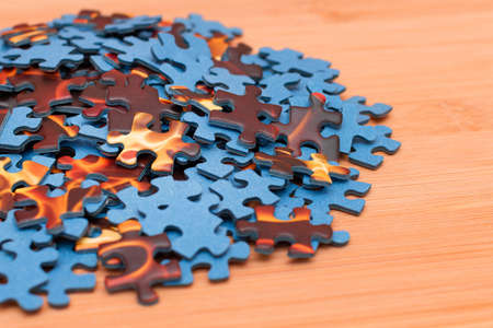 Colorful Peaces of a Mixed Jigsaw Puzzle Lie on the Wooden Table - Strategy and Solving Problem Conceptの写真素材