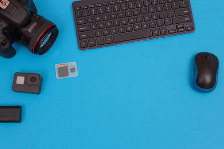 Top View of Photographers, Videographers or Video Bloggers Workplace. Digital Gadgets Lying on Blue Table - Flat Layの写真素材