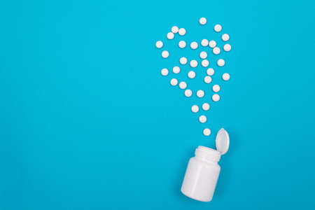 Global Pharmaceutical Industry and Medicinal Products - White Pills or Tablets Scattered from the...