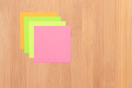 Colored Sticky Notes with Copyspace Pinned to the Wooden Message Board. To Do List Reminder in...