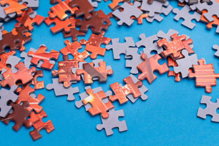 Mixed Peaces of a Colorful Jigsaw Puzzle Lie on the Blue Background - Strategy and Solving Problem Conceptの写真素材