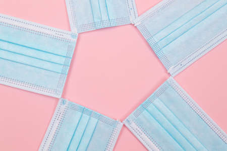 Medical Equipment. Five Disposable Medical Face Masks Lying on Pink Backgroundの写真素材