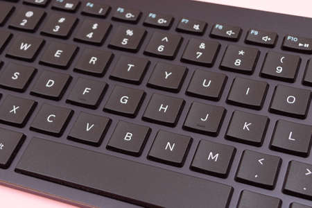 Black Bluetooth Keyboard for Tablet or PC on Pink Backgroundの写真素材