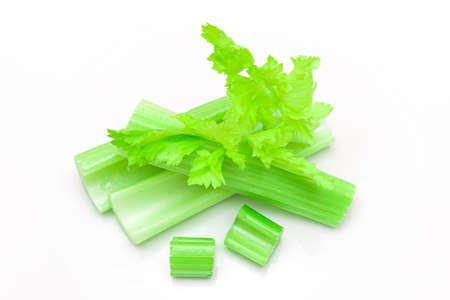 Fresh Chopped Celery Sticks and Slices with Leaves and Water Drops Isolated on White Background. Vegan and Vegetarian Culture. Raw Food. Healthy Diet with Negative Calorie Contentの写真素材