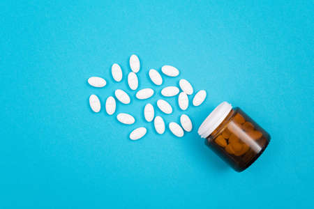 Global Pharmaceutical Industry and Medicinal Products - White Pills or Tablets Scattered from the...
