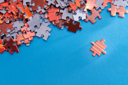 Mixed Peaces of a Colorful Jigsaw Puzzle Lie on the Blue Background - Strategy and Solving Problem Conceptの写真素材