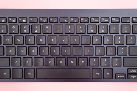 Black wireless Keyboard for Tablet or PC on Pink Backgroundの写真素材