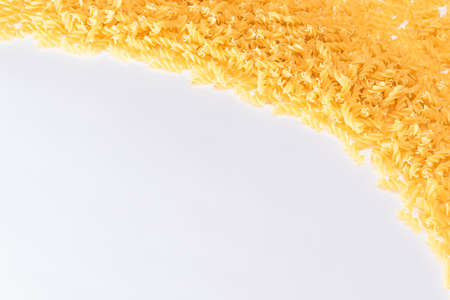 Uncooked Fusilli Pasta with Copy Space on White Background. Raw and Dry Macaroni. Fat and Unhealthy Food - Flat Layの写真素材