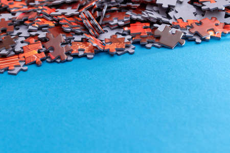Mixed Peaces of a Colorful Jigsaw Puzzle Lie on the Blue Background With Copy Space - Strategy and Solving Problem Conceptの写真素材