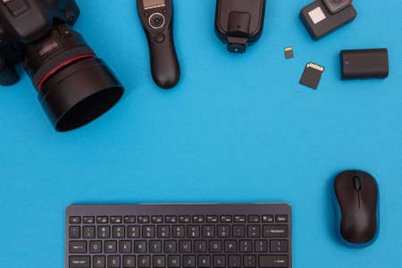 Top View of Photographers, Videographers or Video Bloggers Workplace. Digital Gadgets Lying on Blue Table - Flat Layの写真素材