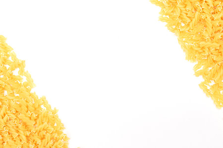 Uncooked Fusilli Pasta with Copy Space on White Background. Raw and Dry Macaroni. Fat and Unhealthy Food - Flat Layの写真素材
