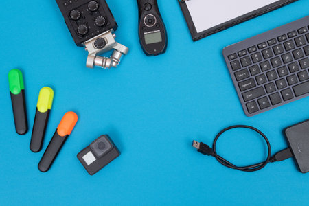 Top View of Photographers, Videographers or Video Bloggers Workplace. Digital Gadgets Lying on Blue Table - Flat Layの写真素材