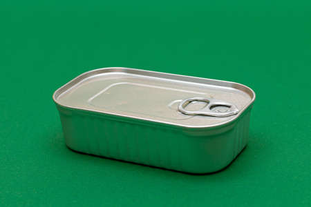 Unopened Tin Can with Blank Edge on Green Background. Canned Food. Aluminum Can for Safe and Long...