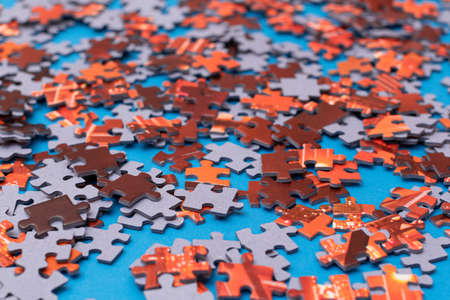 Mixed Peaces of a Colorful Jigsaw Puzzle Lie on the Blue Background - Strategy and Solving Problem Conceptの写真素材