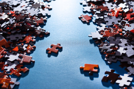 Mixed Peaces of a Colorful Jigsaw Puzzle Lie on the Blue Background - Strategy and Solving Problem Conceptの写真素材
