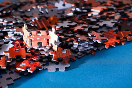 Mixed Peaces of a Colorful Jigsaw Puzzle Lie on the Blue Background - Strategy and Solving Problem Conceptの写真素材