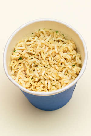 Instant Noodles in Blue Cup on White Background. Asian Fast Food. Quick Lunchの写真素材