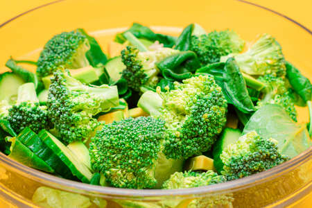Fresh Green Salad of Avocado, Broccoli, Spinach and Cucumber for Body Detoxification - Close-Up. Vegan Salad. Vegetarian Culture. Raw Food. Healthy Eating and Vegetable Dietの写真素材