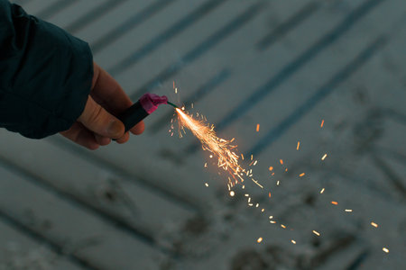 Burning Firecracker with Sparks. Guy Holding a Petard in a Hand. Loud and Dangerous New Years...