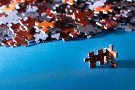 Mixed Peaces of a Colorful Jigsaw Puzzle Lie on the Blue Background - Strategy and Solving Problem Conceptの写真素材