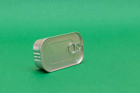 Unopened Tin Can with Blank Edge on Green Background. Canned Food. Aluminum Can for Safe and Long...