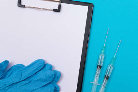 Vaccination, Immunology or Revaccination Concept - Two Medical Syringe Lying on Blue Table in...