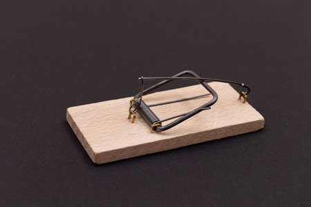Wooden Mouse Trap. Empty Loaded Mousetrap on Black Backgroundの写真素材