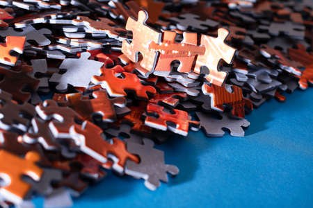 Mixed Peaces of a Colorful Jigsaw Puzzle Lie on the Blue Background - Strategy and Solving Problem Conceptの写真素材